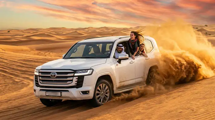 4x4 vehicle kicking up dust as it speeds through the dunes of Abu Dhabi’s Al Khatim Desert, offering an exhilarating dune bashing experience.